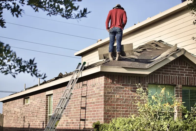 Professional roofer working on a residential roof in Woods Creek